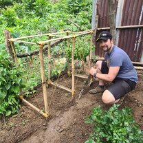 Making a trellis for the cucumber plants we planted!